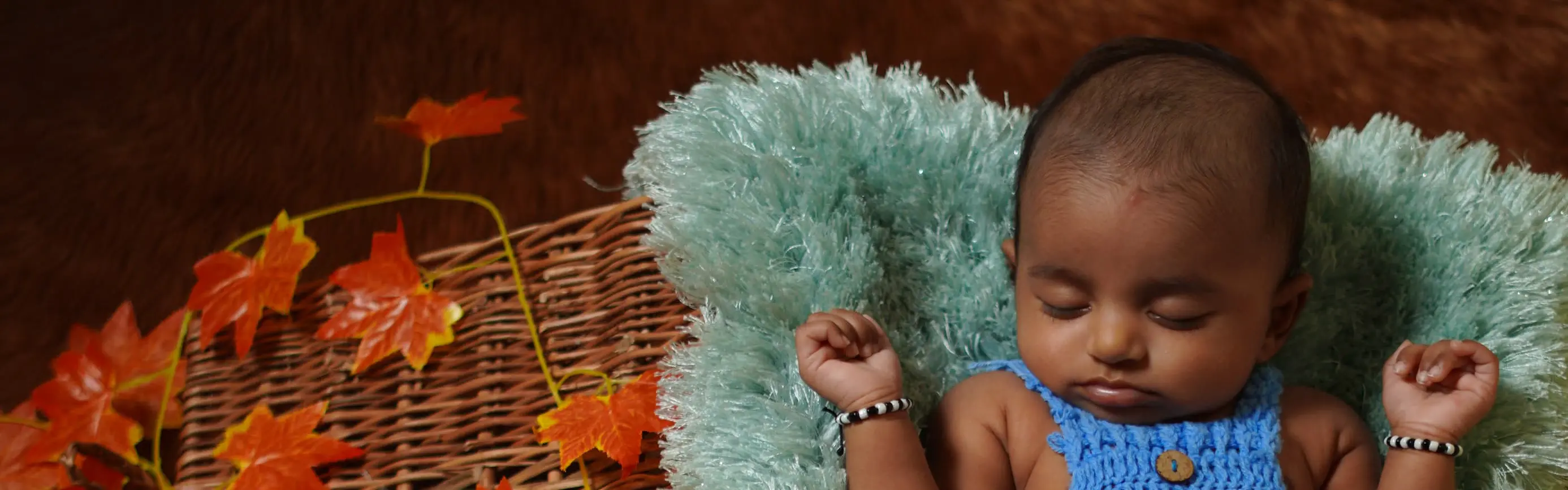Adorable newborn baby photoshoot in a cozy basket setup